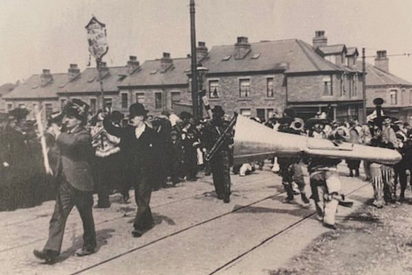 Comic band marching through Saltaire