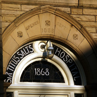 2025.68.54: Salts Hospital front door window in lowlight. Digital image credit: Saltaire Collection